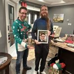 A lab member receiving the fabled Jon photo (yes, it can be won multiple times).